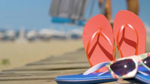 Flip flops, sunglasses and seashells on beach sand.  Stock Footage 135432045