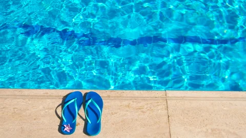 Flip flops by sunny pool. Stock Footage 226850809
