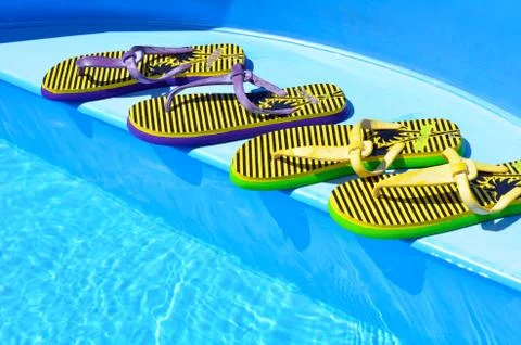 Flip-flops on the swimming pool. Stock Photos
