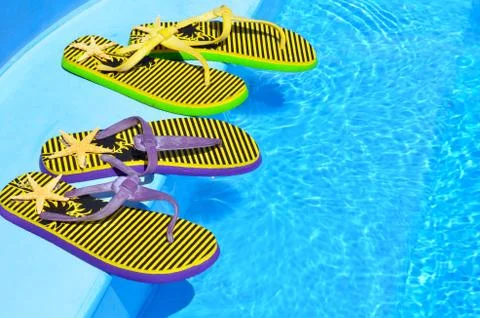Flip-flops on the swimming pool. Stock Photos