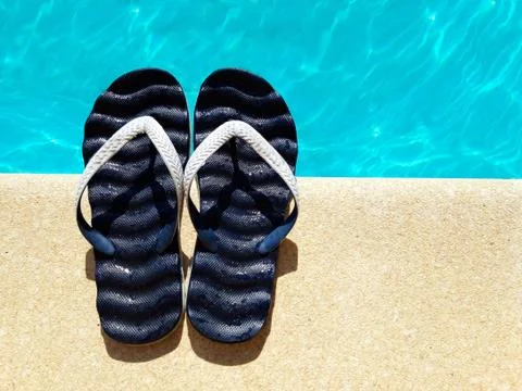 Flip flops by the swimming pool. summer concept 스톡 사진