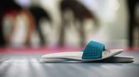 Flip-flops waiting its owner in sport gym Stock Footage 25323452
