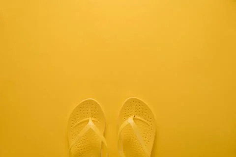 Flip-flops on yellow background Stock Photos