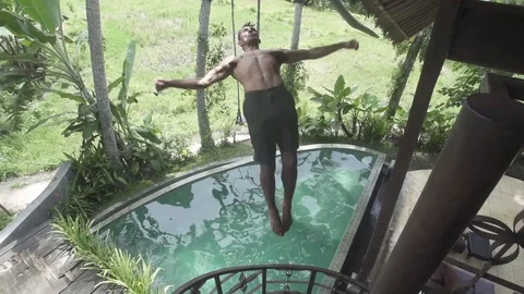 Flip into Hotel Pool in Bali Slow Motion Stock Footage 106782199