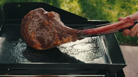 Flip over tomahawk streak on flat grill Stock Footage 276668950