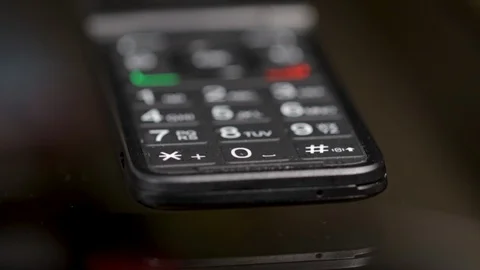 Flip phone  close up key pad of old cell phone. Macro view of old hand held mobi Stock Footage 126254096
