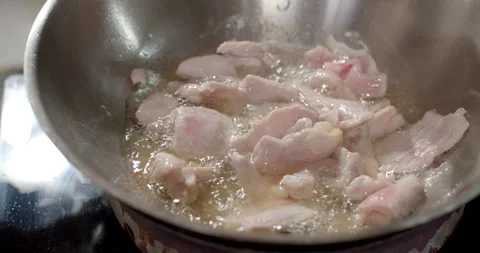 Flip the pork over the pan with a spatula so that the unheated strips Stock Footage 240943870