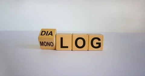 Fliped a cube and changed the German word 'monolog' - 'monologue' in English  Stock Photos