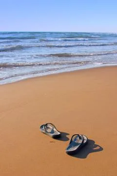 Flipflops on a sandy beach Stock Photos