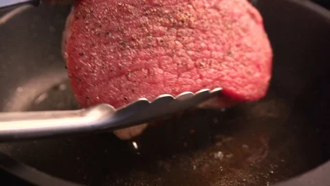Flipped raw steak beef grilled well done. Slow motion. close up Stock Footage 73857125