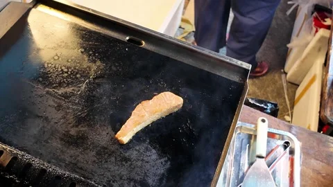 Flipped salmon steak grilling on flat plate 스톡 동영상 347528838