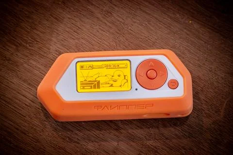 Flipper Zero with orange rubber protective case Stock Photos