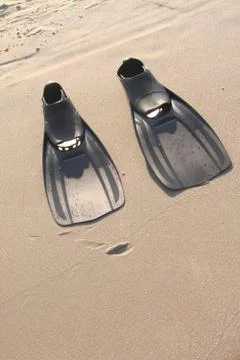 Flippers in the sand at the beach Stock Photos