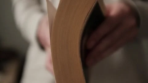 Flipping and old book with yellowed pages. Flicking through an old textbook. Stock Footage 321427322