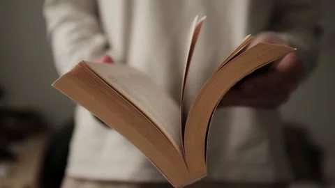Flipping and old book with yellowed pages. Flicking through an old textbook. Stock Footage 321427357