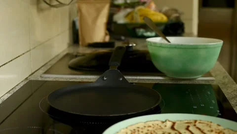 Flipping and plating a fresh, hot pancake. Stock-Footage 314430459