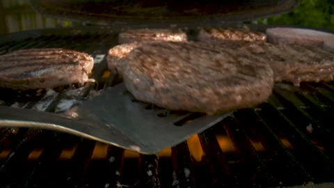 Flipping a burger on the grill. Stock Footage 132409317