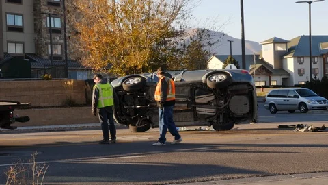 Flipping a car over on its wheels after a roll over accident.  Stock Footage 98103734
