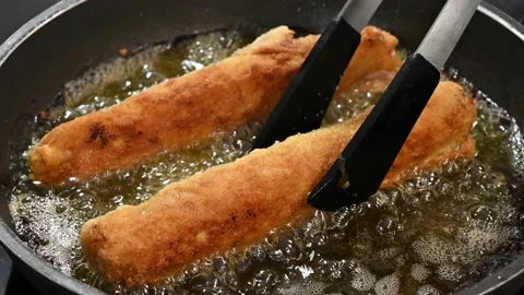 Flipping chicken, ham and cheese rolls Stock Footage 219674532