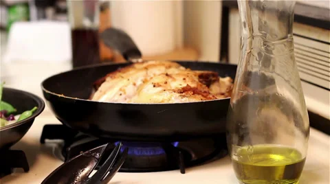 Flipping chicken over with a knife Stock Footage 32114393