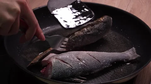 Flipping a Cooked Fish in Pan. Stock Footage 258562985