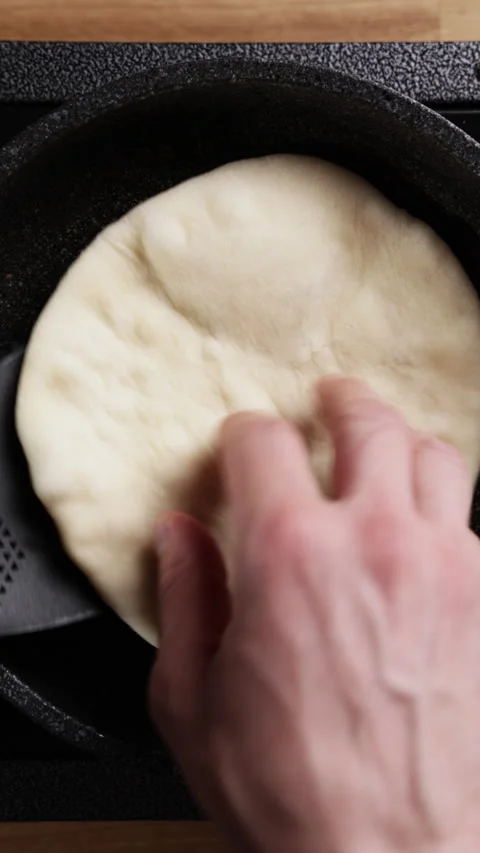 Flipping Flatbread Dough In Frying Pan Top View Видео 330573592