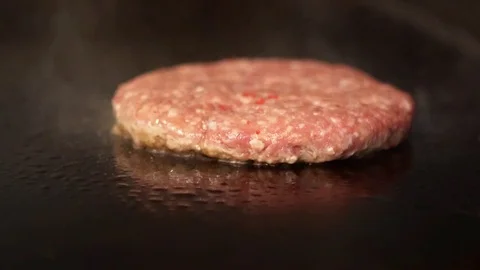 Flipping fresh burger on a grill Stock Footage