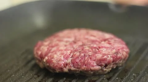 Flipping hamburger on a frying pan Stock Footage 12516860