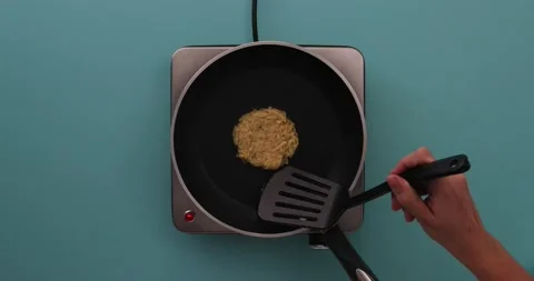 Flipping the hash browns in a pan 1 Stock Footage 132149772