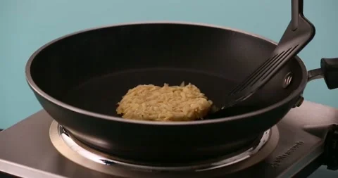 Flipping the hash browns in a pan 2 Stock-Footage 132149769