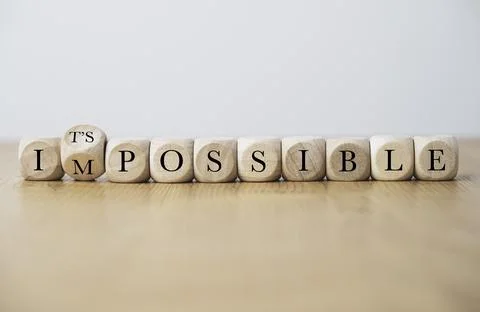 Flipping of Impossible and possible wording on wooden cube block for changi.. Stock Photos