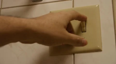 Flipping light switch Stock Footage