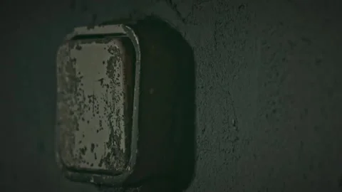 Flipping an Old, Dirty Light Switch in a Dark Room with Audio Video stock 329764260