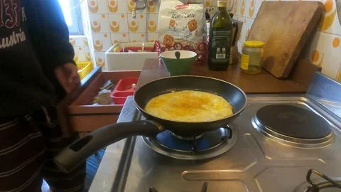 Flipping an omelet in the frying pan Video stock 229492536