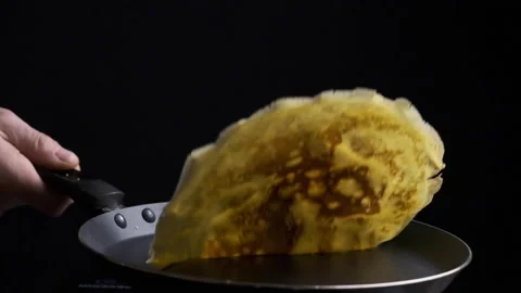 Flipping over a baking pancake slow motion Stock Footage 169237268