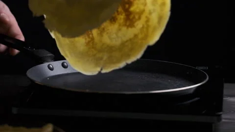 Flipping over a pancake baking slow motion Stock Footage 169237345
