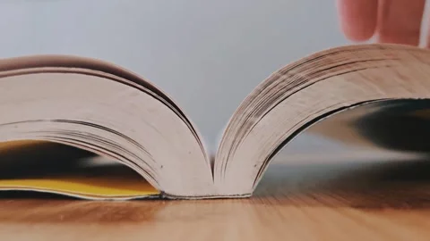 Flipping the pages of a book close-up Stock Footage 304304719