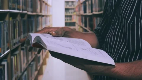 Flipping pages of book in the library Stock Footage 249286744