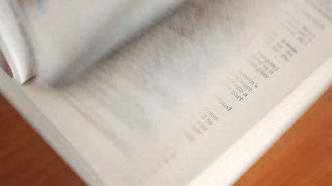Flipping pages in a dictionary, an encyclopedia, a book, close Stock Footage 97923297