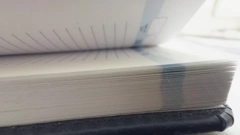 Flipping pages in a notebook or planner, side view showing the texture of t.. Stock Footage 303842993