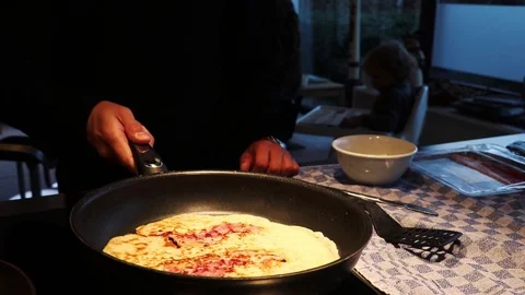 Flipping pancake with bacon in pan Stock Footage 129432090