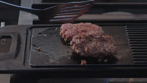 Flipping Perfection: Turning the Burger with Precision Stock Footage 258299474