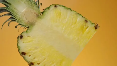 Flipping pineapple on yellow background Stock Footage 274814895