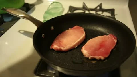 Flipping Porkchops on a Skillet Stock Footage 11857519