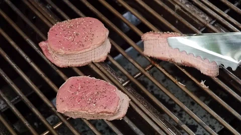 Flipping rare beef on BBQ Video stock 114183220
