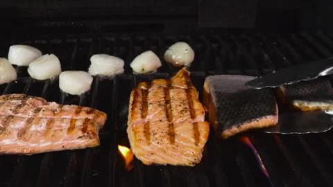 Flipping Salmon on the Grill Stock Footage 243584896