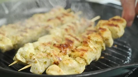 Flipping the skewer in the grill. Stock Footage 207024512