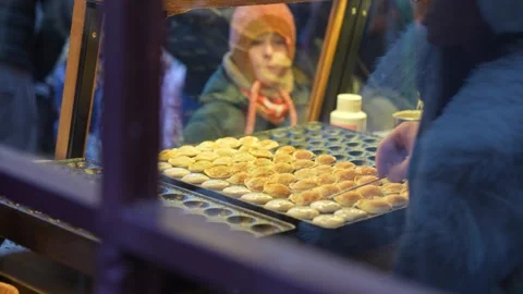 Flipping small pancakes on a griddle to cook them golden brown on the other side Stock Footage 326124689