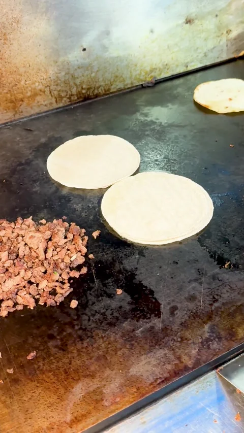 Flipping Small Tortillas on Griddle Stock Footage 318749333