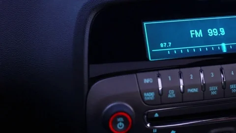 Flipping stations in the car radio Stock Footage